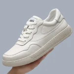 White lace-up leather sneakers with a textured sole